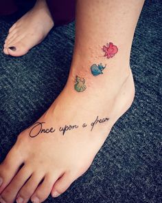 a person has a tattoo on their foot that says, once upon a year and three little birds