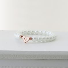 Children's Initial and Heart Bracelet Flower Girl Gift Kids Jewelry Wedding Gift for Kids Flower girl Proposal Baby Child Infant Bracelet This adorable bracelet features a row of faux glass pearls with an adorable heart charm hand stamped with a letter of your choice. Choose from ivory or white pearls , silver, rose gold or gold heart charm and font style. How to order -Select pearl colour and size from the drop down menu - Select you heart colour and font option from the drop down menu -add in White Heart Beads Bracelet For Weddings, White Heart-shaped Beaded Bracelets For Wedding, Wedding White Heart Beads Bracelets, Heart-shaped Beaded Bracelets For Wedding, White Heart Bracelet For Wedding, White Heart-shaped Bracelet For Weddings, Adjustable Beaded Bracelets With Heart Charm For Wedding, White Pearl Bracelet With Heart Charm For Wedding, Elegant Pearl Bracelet With Heart Beads For Wedding