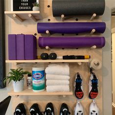 there are many different items on the shelf in this room, including shoes and yoga mats