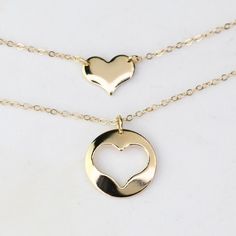 Mother Daughter Necklace Set. 14K gold necklace  Mother's necklace: - 14K gold charm is about 13mm, it is 22 gauge. - 14K gold necklace Daughter's Necklace: - 14K gold heart charm is about 10mm x 8mm, it is 22 gauge. - 14K gold necklace Necklace size chart: average 0 - 12 months 10" average 12 - 24 months 12" average 2-3 years 13" average 4-5 years 14" average 5-10 years 15"-16" 14K gold components Your necklaces will be shipped in a gift box. To see other Mother daughter set click here: https://www.etsy.com/shop/SashJewelry?section_id=12441134&ref=shopsection_leftnav_1 To see more children's jewelry click on the link below. http://www.etsy.com/shop/SashJewelry?section_id=12441132 To see more Sash Jewelry items click on the link below. http://www.etsy.com/shop/SashJewelry Please don't hesi 14k Gold Filled Yellow Gold Charm Necklace For Anniversary, 14k Gold Necklace For Valentine's Day, 14k Gold Pendant Charm Necklace For Valentine's Day, Yellow Gold Minimalist Heart Necklace, 14k Gold Filled Necklaces For Valentine's Day Anniversary, 14k Gold Heart Necklace For Valentine's Day, 14k Gold Round Heart Necklace For Valentine's Day, Dainty 14k Gold Charm Necklace For Anniversary, 14k Gold-filled Yellow Gold Charm Necklaces For Anniversary