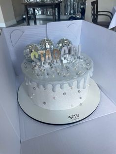 a cake in a box with the word sparkle spelled out on it's side