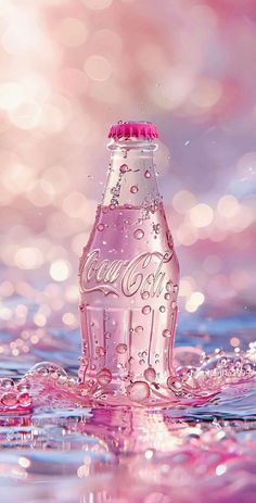 a pink coca - cola bottle floating in the water with bubbles on it's surface