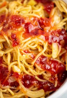 a bowl filled with spaghetti and sauce on top of a table