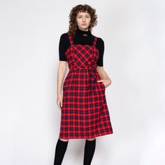 Vintage 70s red & black plaid midi pinafore dress with a matching optional tie at the waist, and hip pockets. Shown modeled over a black top, not included with purchase. Measurements and Condition: Fits like: Labeled size 12, fits modern women's medium Fabric: Feels like wool - labeled dry clean only Brand: Route One Petite Miss, union made in USA Condition: Excellent Length: 41.5" Chest: 37" Waist: 28" - cinches with tie Hips: 43"  Shown on a 5'8" model with measurements of 34"-26"-37", usually Midi Pinafore Dress, Overall Jumper, Union Made, Pinafore Dress, Vintage Belts, Red And Black Plaid, Dress Vintage, Jumper Dress, Black Plaid