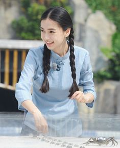 a woman standing in front of a table with glasses on it