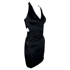 Presenting a black satin Gucci halterneck mini dress, designed by Alessandra Facchinetti. From the Spring/Summer 2005 collection, this dress features gathering at the front, cutouts at the back, and a concealed zipper at the side. Approximate measurements: Size - 38IT Bust: 28 - 30" Waist: 24 - 27" Hips: 30 - 34" Halterneck to hem: 34" 93% silk, 7% spandex Vampire Core, Black Satin Mini Dress, Halterneck Mini Dress, Gucci Spring, Halter Neck Dress, Dress Halter, Satin Mini Dress, Halterneck Dress, Gucci Black