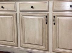 a kitchen with white cabinets and granite counter tops