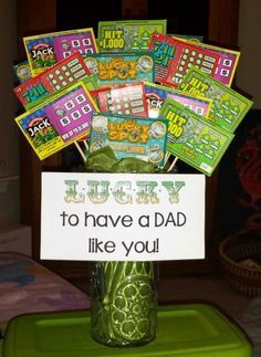 a green vase filled with lots of cards on top of a table next to a sign that says i have a dad like you