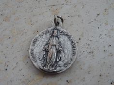 Religious antique French catholic silvered medal pendant Holy charm medallion of Saint Maria Goretti and Holy Virgin Mary. Measures are 0,64 x 0,77 inches ( 1,62 x 1,96 cm ) I bought this beautiful antique locket shrine on a brocante ( fleamarket ) in France. I deliver all over the world. If you want more photos or information, you can contact me. If you don't have paypal, you can pay by bank transfer. Registered shipping is possible. Please take a look at my other items for sale. Silver Miraculous Medal Pendant, Silver Pendant With Miraculous Medal, Saint Maria Goretti, St Maria Goretti, Maria Goretti, St Maria, Antique Locket, Our Lady Of Sorrows, Catholic Medals