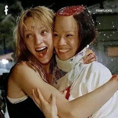 two women hugging each other in the rain