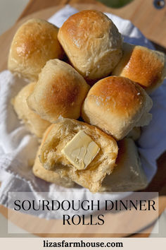 several rolls with butter on top and the words sourdough dinner rolls above it