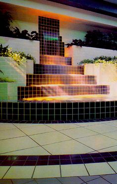 a tiled fountain in front of a building