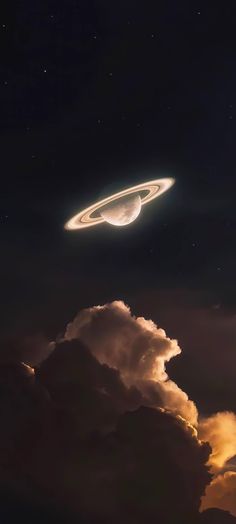 an object is flying in the sky above some clouds and dark night skies with stars