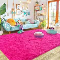 a living room filled with furniture and pink rugs