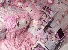 a bedroom with hello kitty bedding and stuffed animals