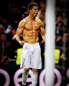 a shirtless male soccer player standing on the field