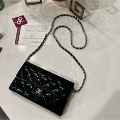 Authentic Black Chanel Flap Wallet On Chain With Silver Hardware. This Is A Pre-Loved Item And Is In Overall Great Condition And Is Super Cute. Wallet Can Be Worn Crossbody, Shoulder, Or The Chain Can Be Looped For A Shorter Bag Shoulder Style. The Chain Is Unbranded And Comes With The Wallet To Make It A Wallet On Chain. Date Serial Code 15447581. Length 7.1 Inches, And Height 4.3 Inches. The Typical Size Of A Small Crossbody. This Is A Preloved Item, Expect Wear On This Item. There Are Mild Wear Marks On The Edges, Buttons, Mild Scratches, Some Fading Inside, Wear In Coin Compartment And Inside Wallet. Chanel Wallet On Chain, Cute Wallet, Wallet On Chain, Chanel Wallet, Small Crossbody, Bag Shoulder, Silver Hardware, Chanel Bag, Leather Wallet