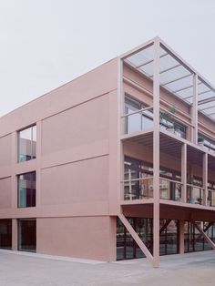 a large pink building with lots of windows