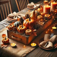 a wooden box filled with lots of pumpkins on top of a dining room table