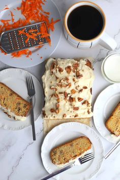 carrot cake with cream cheese frosting and pecans on plate next to cup of coffee