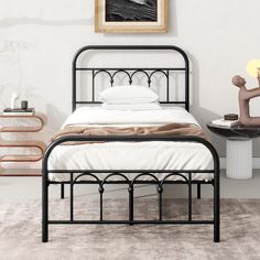 a black metal bed frame in a white bedroom