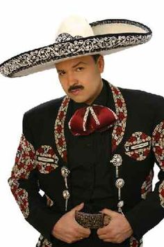 a mexican man wearing a sombrero and holding his hands in his pockets