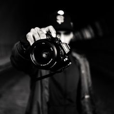 a man holding a camera up to his face