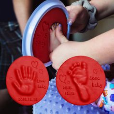 two hand and foot imprints are shown in red plastic