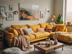 a living room with yellow couches and pictures on the wall above them, along with a coffee table