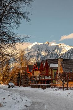 a large house with mountains in the background