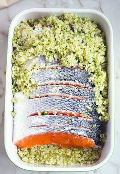 fish and rice in a white dish on a table