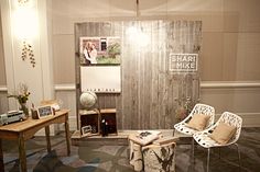 a couple of chairs sitting next to each other in front of a wooden paneled wall