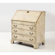 an old white wooden dresser with drawers