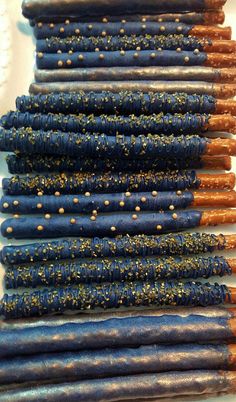 several blue and gold colored candles are lined up