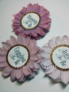 three pink and white flowers with gold sequins on them, one is for grandma and the other is for grandma