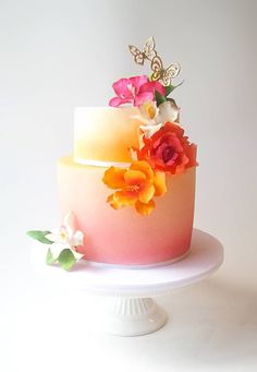 there is a multi layer cake with flowers on it