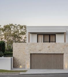 a modern house with stone walls and doors