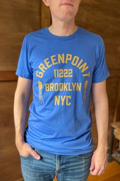 *Orders placed after December 11 are not guaranteed to arrive by Christmas* *Online only. This tee will be printed specially for you and may ship separately from other items in your order. Ships within a few days* What’s comfier than a casual tee? A premium casual tee. Rep your favorite neighborhood in this unisex Greenpoint jersey t-shirt. It features a crew neck, short sleeves and a new modern relaxed fit for effortless style. Design is exclusive to Local Color NYC. Solid colors are 100% cotto Retro Tri-blend Crew Neck T-shirt, Sporty Screen Print T-shirt For Everyday, Sporty Everyday T-shirt With Screen Print, Blue Crew Neck T-shirt With Front Print, Retro Pre-shrunk T-shirt For Everyday, Retro Everyday Pre-shrunk T-shirt, Blue Pre-shrunk T-shirt For Everyday, Blue Cotton T-shirt With Text Print, Everyday Blue Soft-washed T-shirt