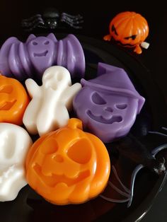 halloween soaps on a black plate with jack - o'- lanterns