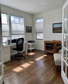 an office with hard wood floors and windows