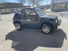 a black truck parked in a parking lot