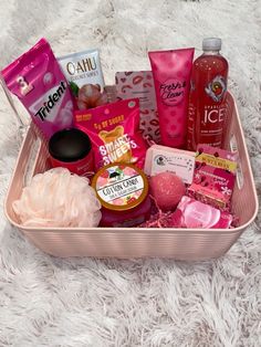 a pink basket filled with lots of different types of cosmetics and personal care products on a white carpet