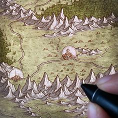 a hand holding a pen drawing a landscape with mountains