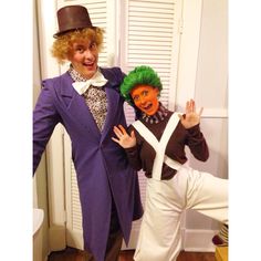 two people dressed up in costumes posing for the camera with one holding his hand out