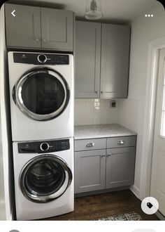 a washer and dryer sitting in a kitchen next to each other on top of cabinets