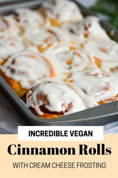 a pan filled with cinnamon rolls covered in icing and sitting on top of a table