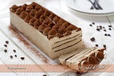 a piece of cake sitting on top of a table next to a plate with chocolate chips