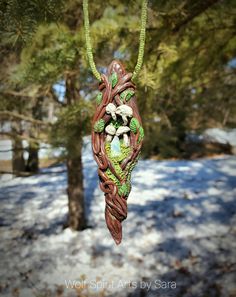 "In the forest there lies another world beyond the veil. A world, that when entered, is a world of beauty, fantasy, and ethereal beings. The Elven race, Fae, Fawns, Dryads...and many others! These Forest Keys are the keys for the doors to step through the veil! Each one has a crystal to aid you in your journey into this magical world!\" This Forest Key holds a small yet flashy Welo Opal nugget that is surrounded by Moss and tiny mushrooms! This piece was made to look like a twisted and viney \"k Hand Painted Green Spiritual Jewelry, Green Hand Painted Spiritual Jewelry, Spiritual Hand Painted Green Jewelry, Handmade Resin Jewelry Nature-inspired, Whimsical Clay Jewelry Gift, Whimsical Clay Jewelry For Gifts, Handmade Fantasy Green Necklaces, Handmade Green Fantasy Jewelry, Handmade Green Fantasy Necklace