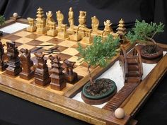 a chess board with plants on it and other pieces in the middle, sitting on a table