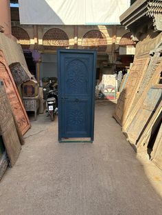 an open blue door sitting in the middle of a room